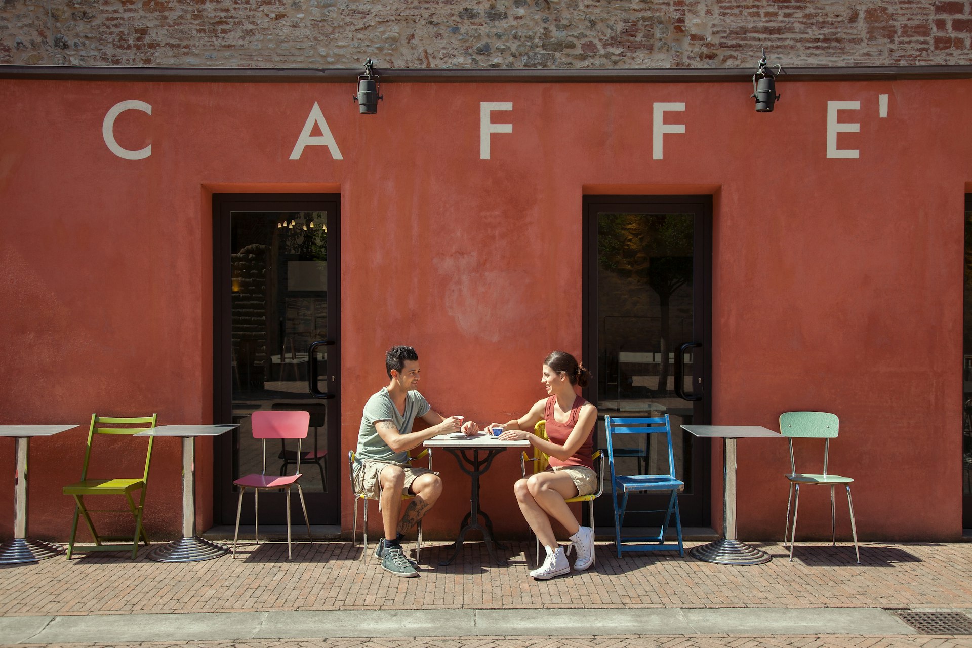 Couple sitting outside cafe, Florence, Tuscany, Italy